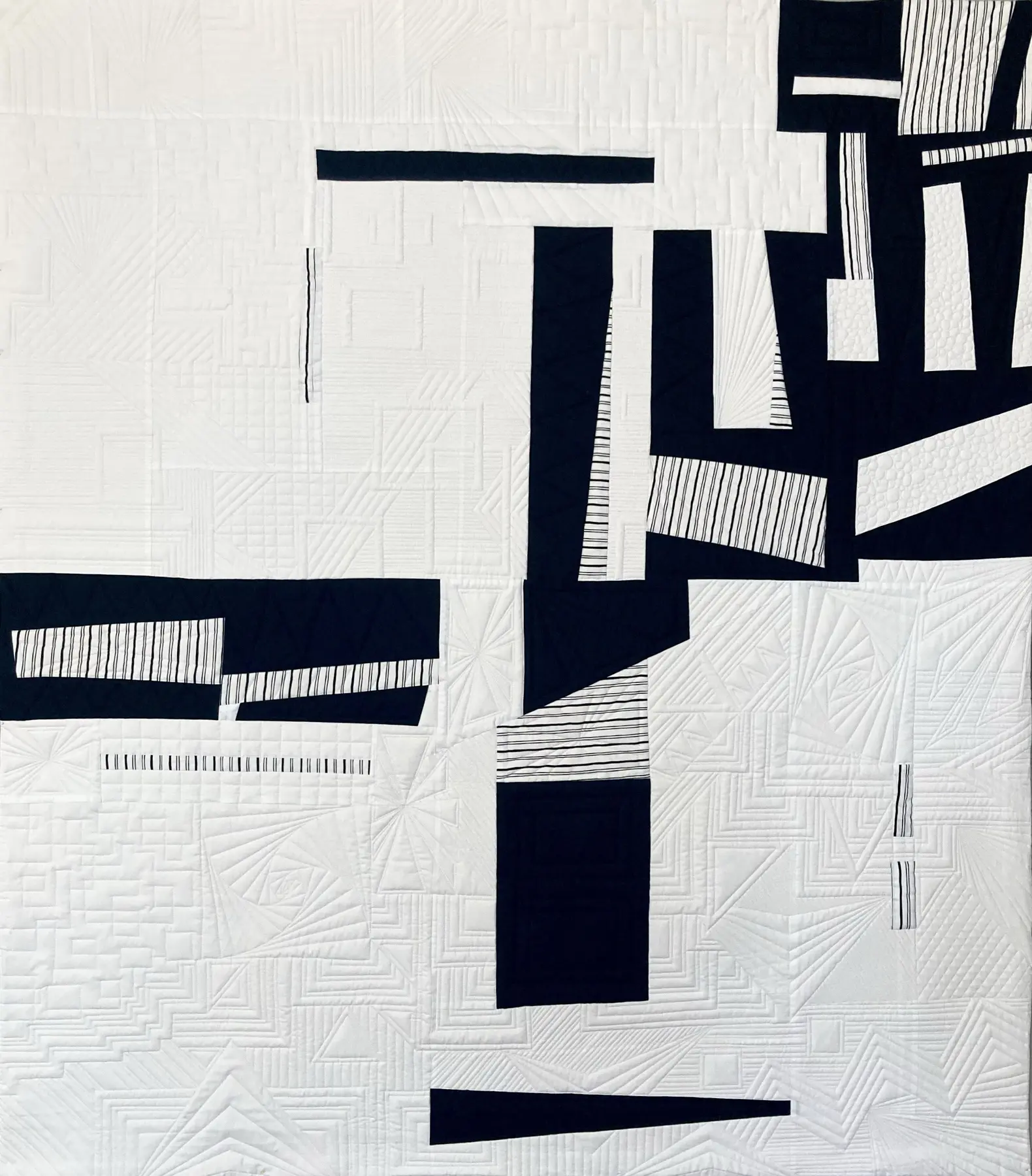 Minimal black and white art quilt with angular black lines concentrated on the right