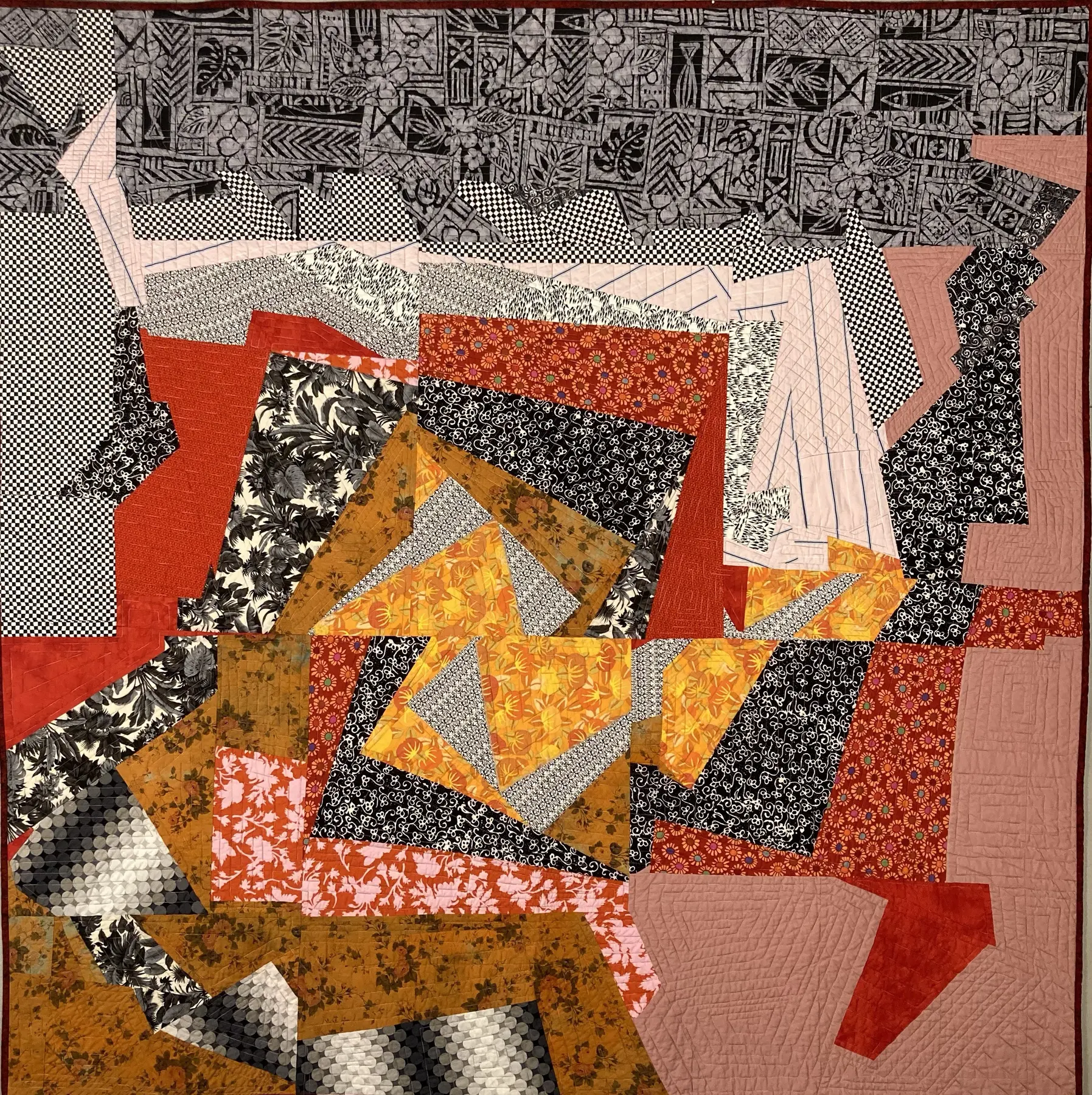 Art quilt with energetic orange, black, grey and pink angular shapes