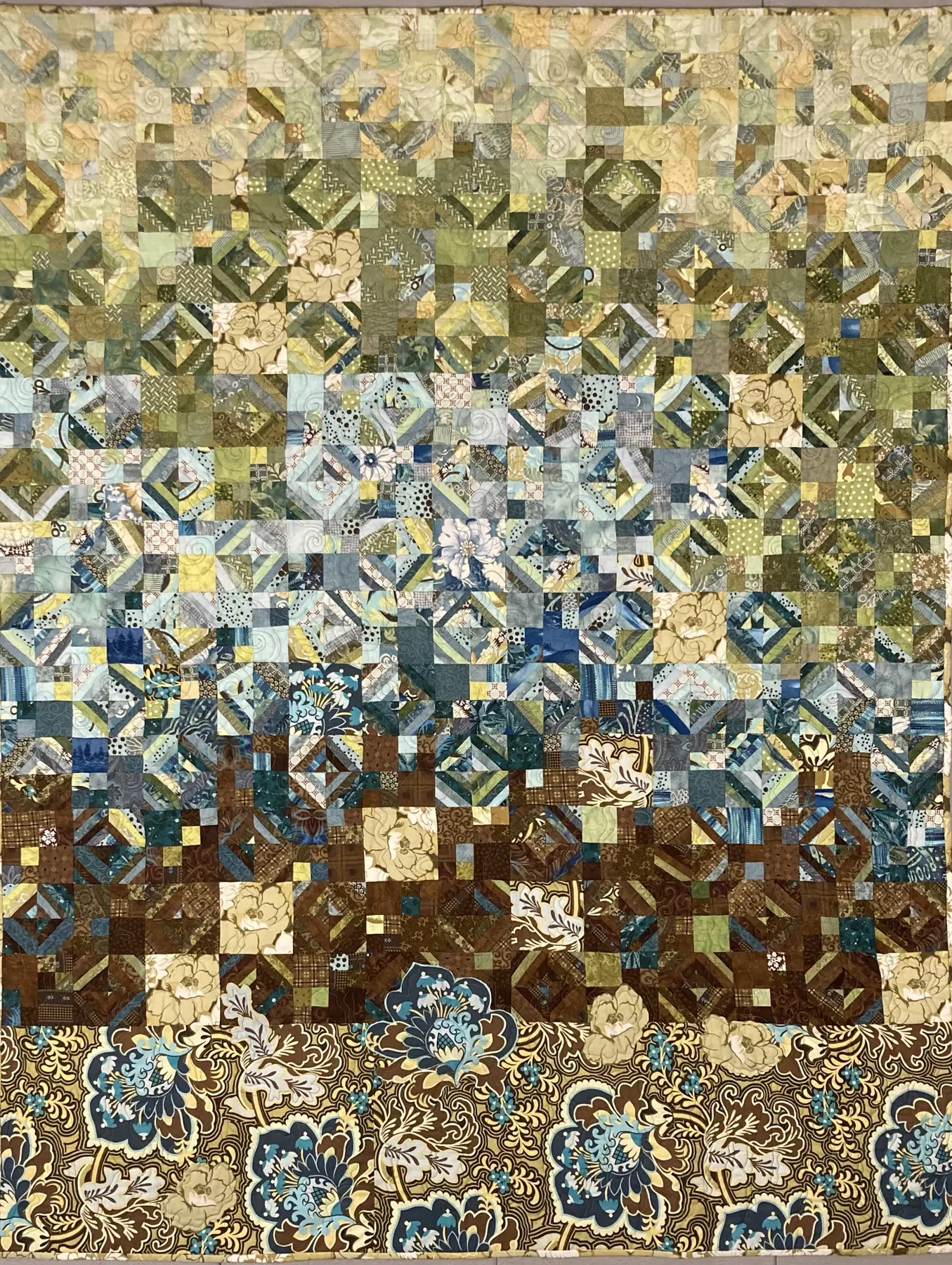 Intricately patterned pale blue, cream and brown art quilt suggesting a layered garden