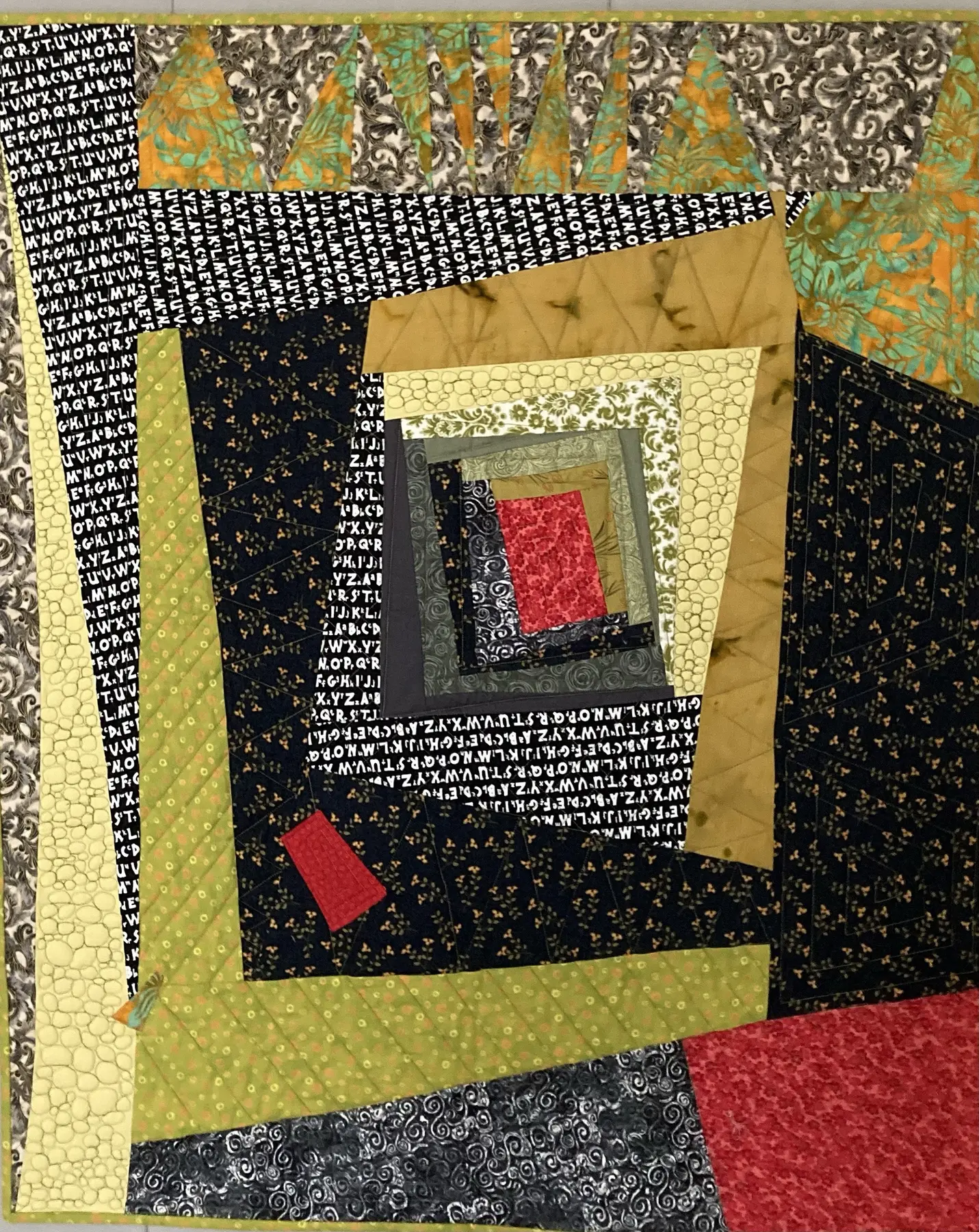 Irregularly shaped art quilt with offset black, cream, olive and burgundy frames
