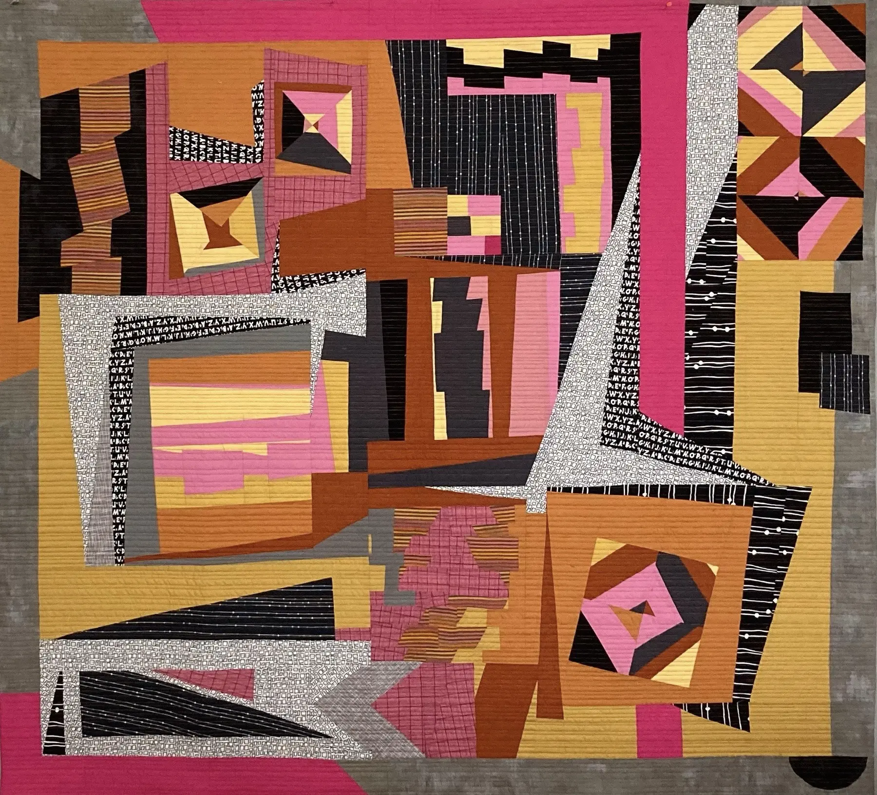 Art quilt of interwoven pink, black, ochre and cream geometric blocks